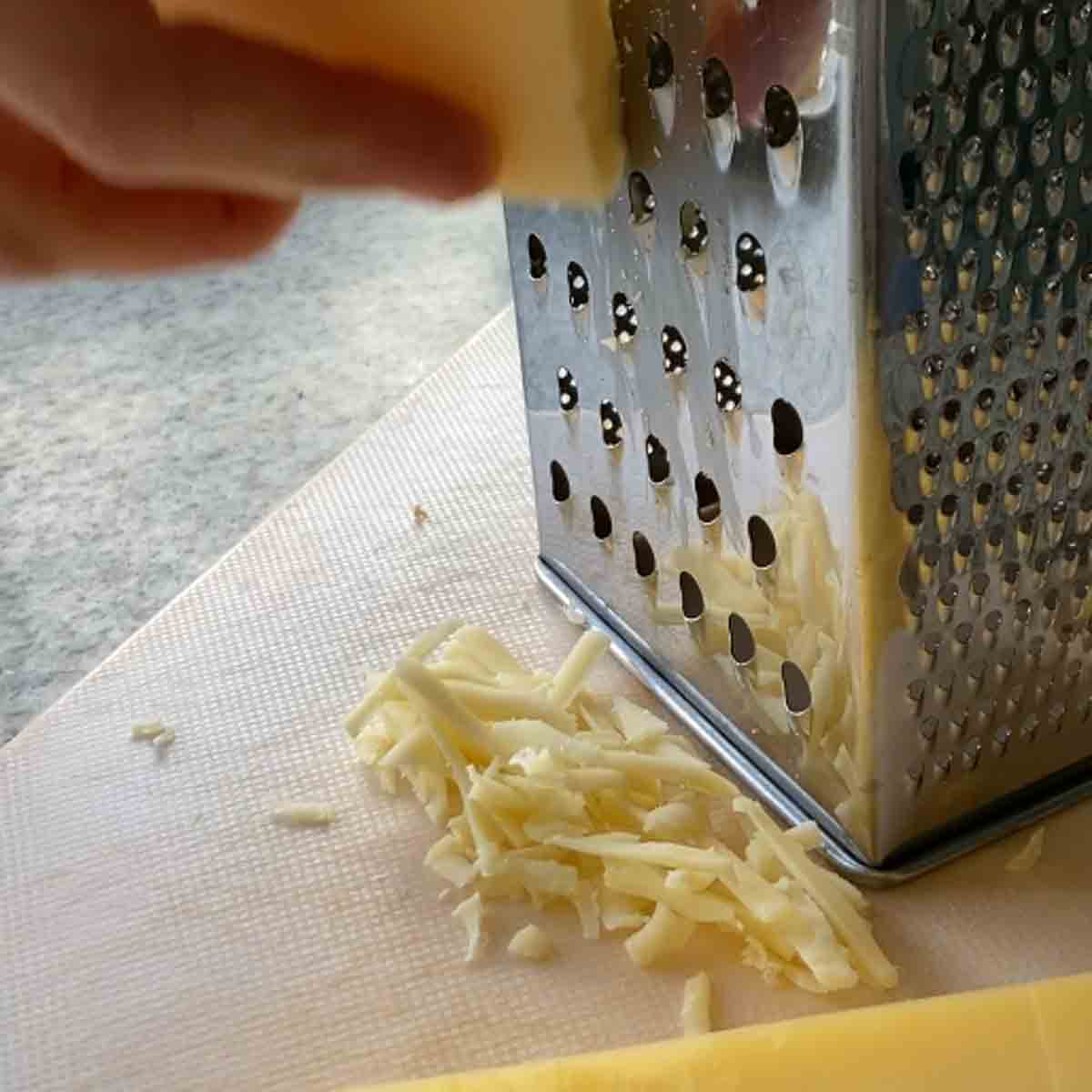Grating cheese with box grater.