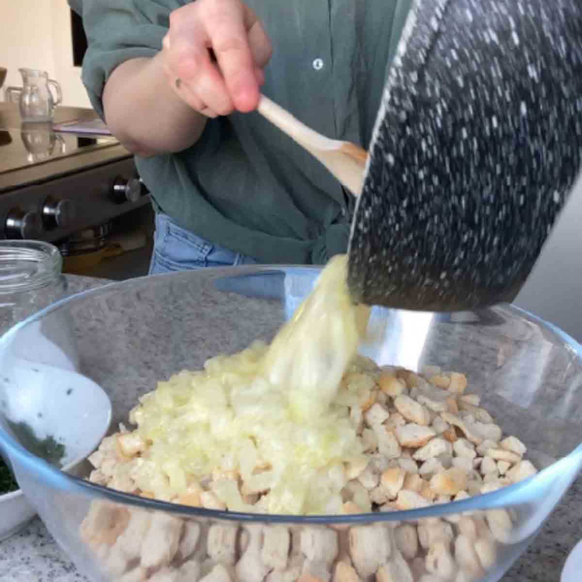 Pouring onion over breadcrumbs.