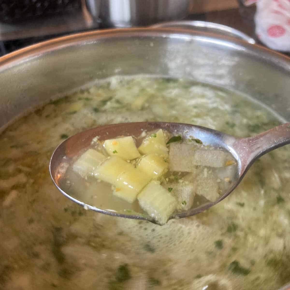 Cooked potato cubes in soup.